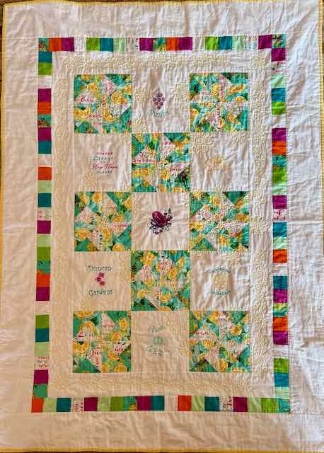 Whimsical patchwork and machine embroidered/quilted summer quilt.