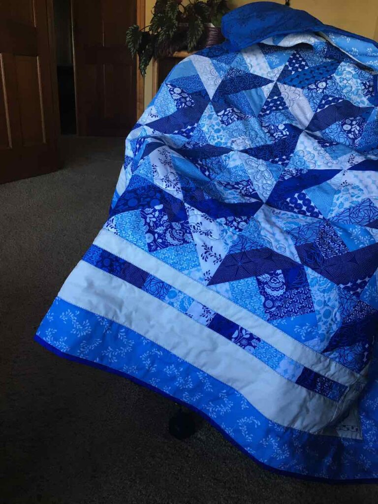A strip pieced quilt finished and ready to gift to my friend
